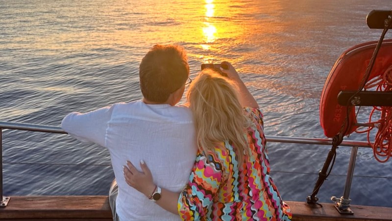 a person standing next to a body of water