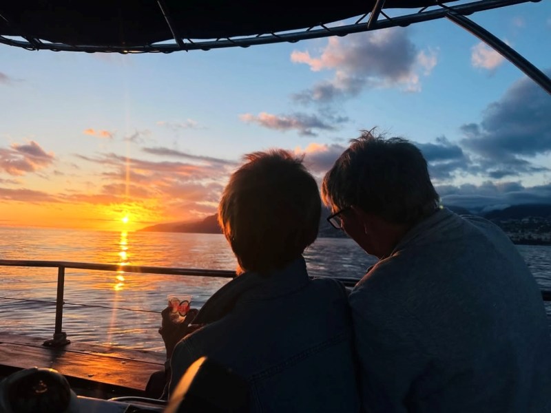 a man standing in front of a body of water
