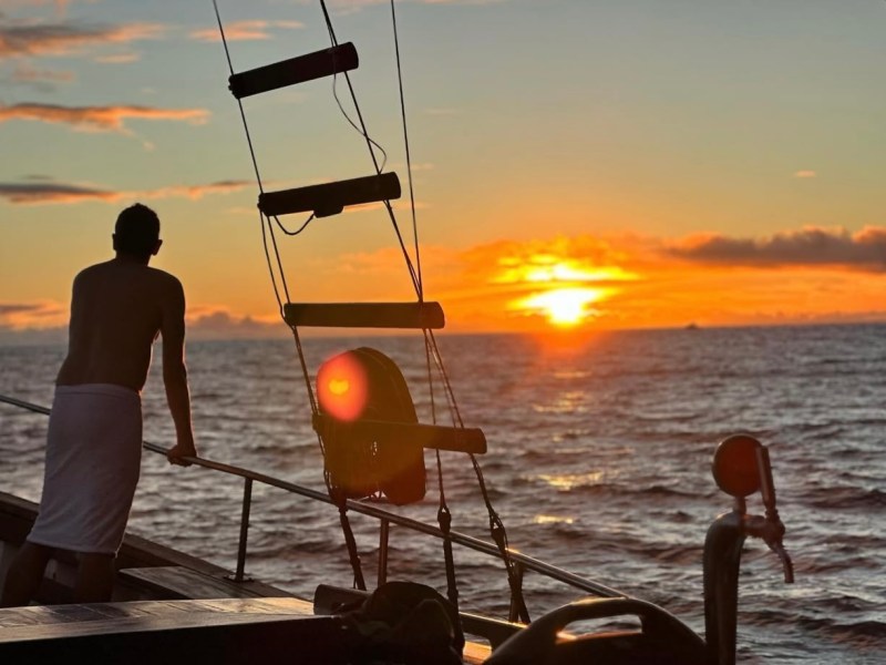 a man standing next to a body of water