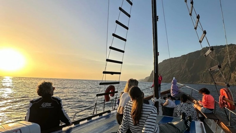 a group of people in a boat on a body of water
